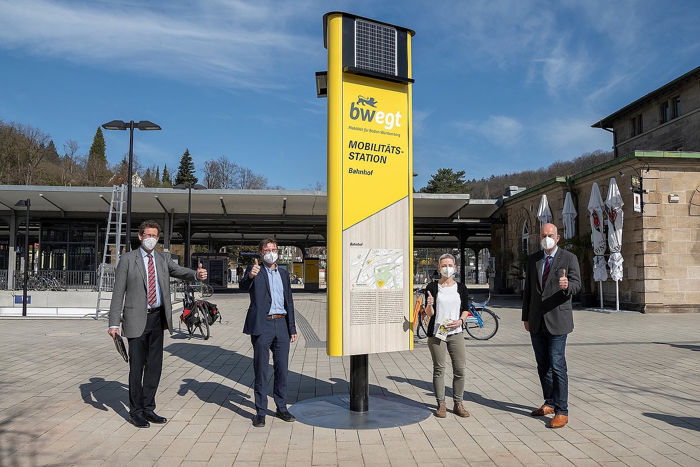 Menschen aus dem Verkehrsministerium stehen vor einer Mobilitätssäule